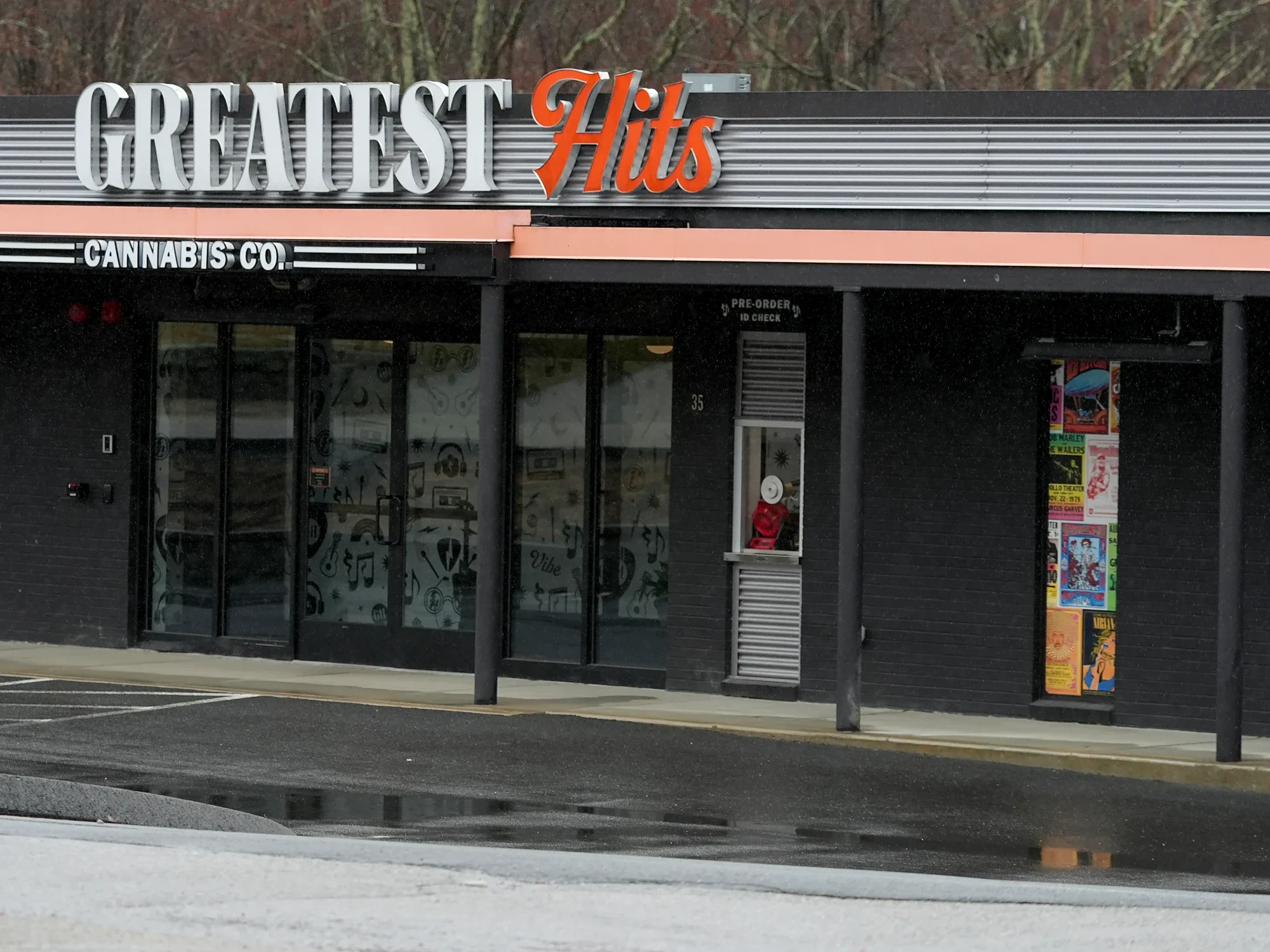 The built storefront: the wordmark in channel letters, the pick, the pre-order window, and the poster wall.
