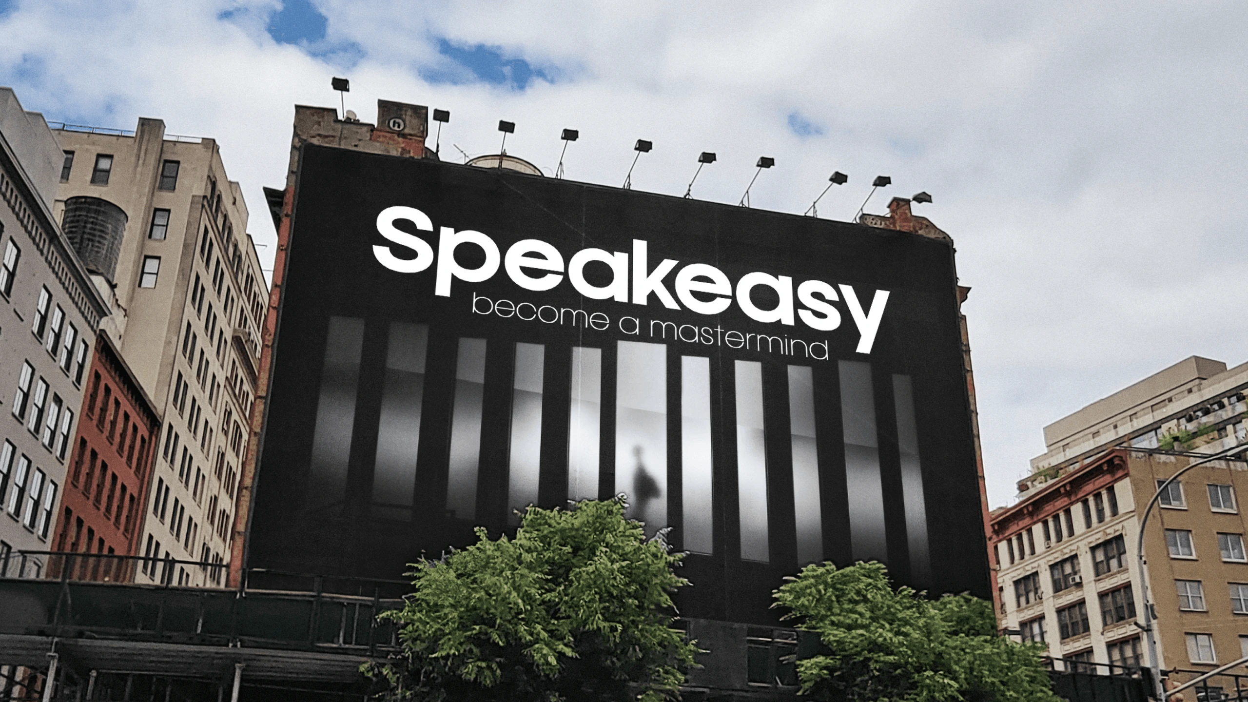 A building-scale Speakeasy billboard reading “become a mastermind” above a row of lit windows.