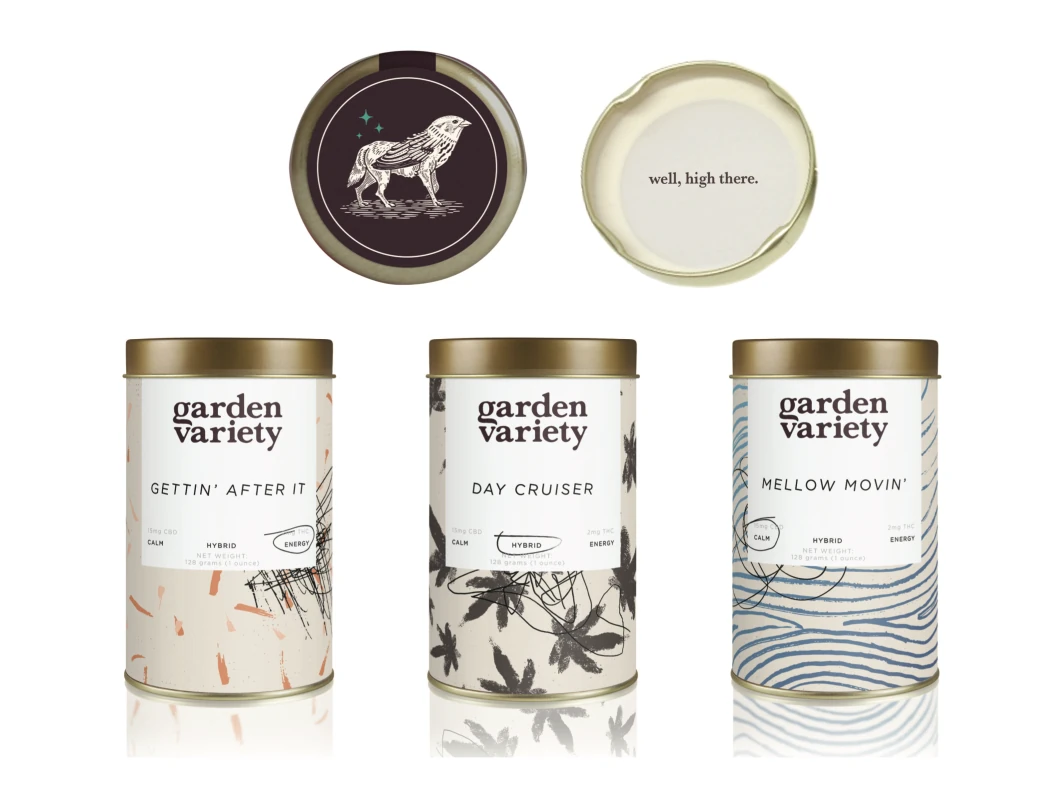 Three cream tins in a row, each with the wordmark and a different botanical pattern, their lids above