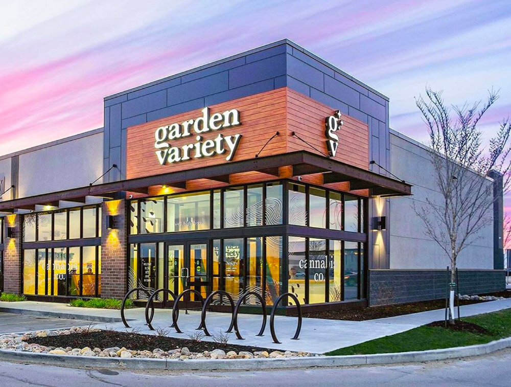 The Garden Variety storefront at sunset, the wordmark lit over the glass front