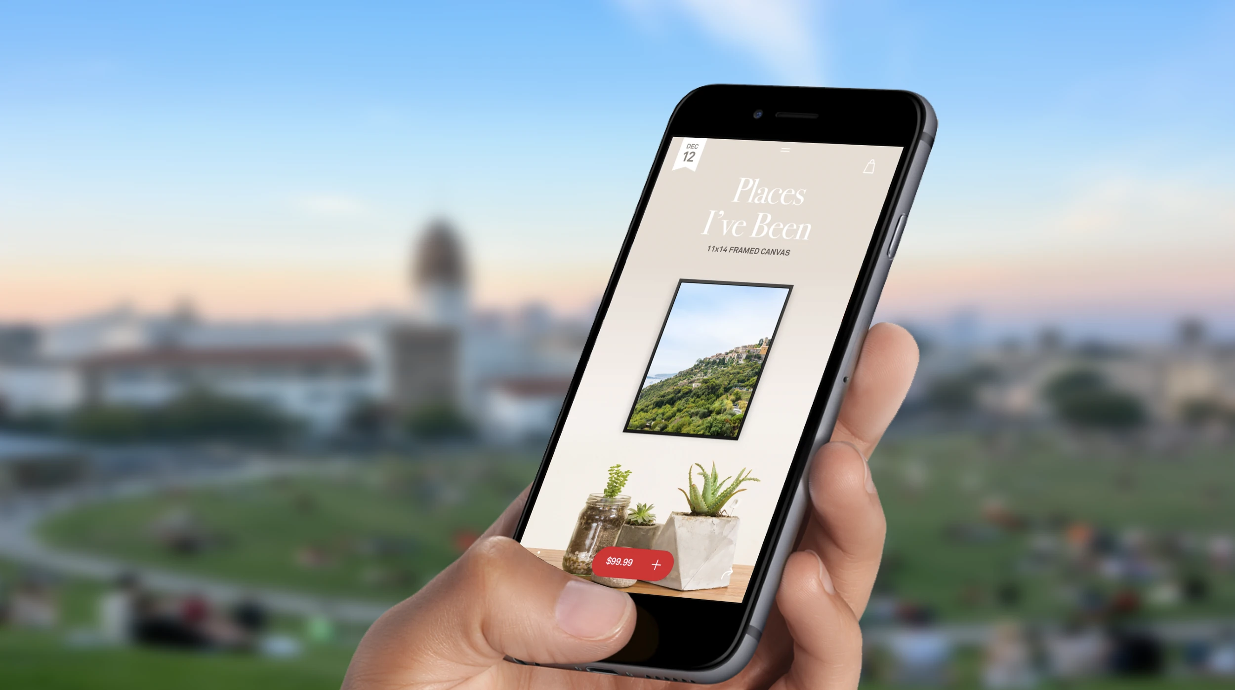 A phone held over a park, the Places We Love moment on screen