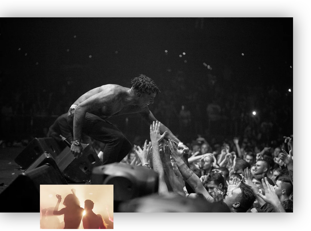 A black-and-white concert crowd, the singer leaning over the front row