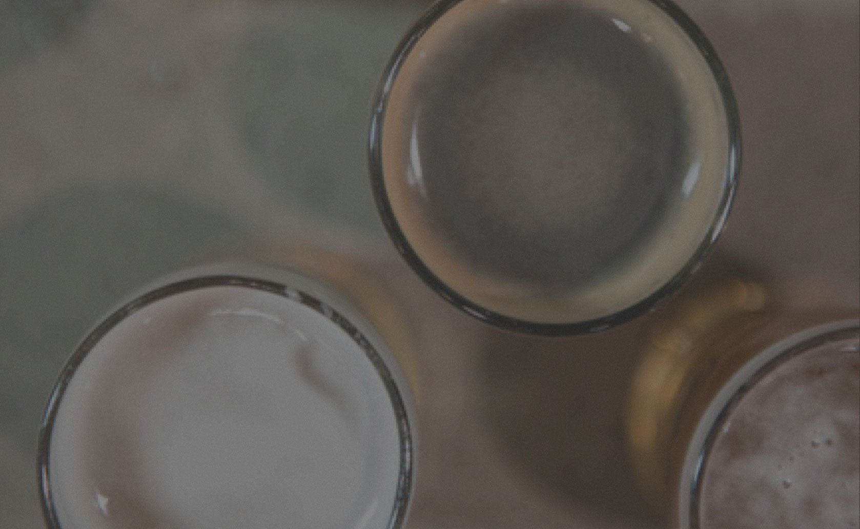 Three pint glasses from above on a bar